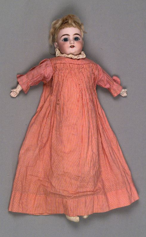 Bisque doll dressed in handmade clothes, 1890-1900