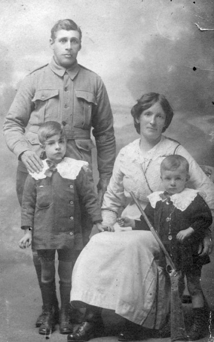 Studio portrait of Private Alf Lovett with his wife and sons, 1915